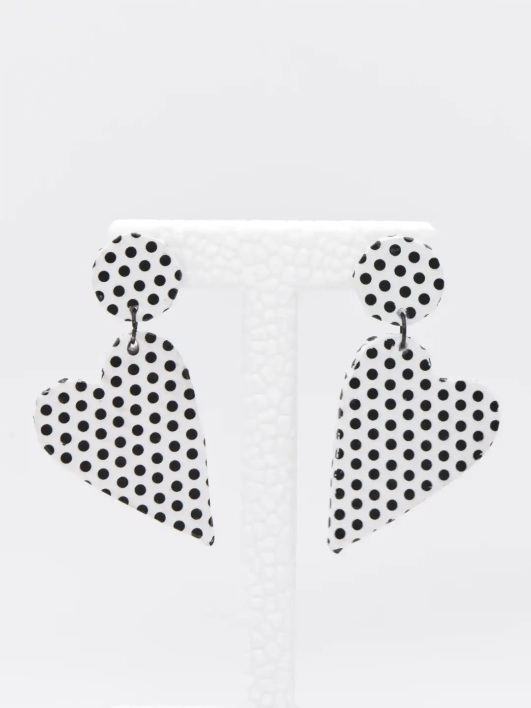 White black polka dot teardrop earrings on display stand