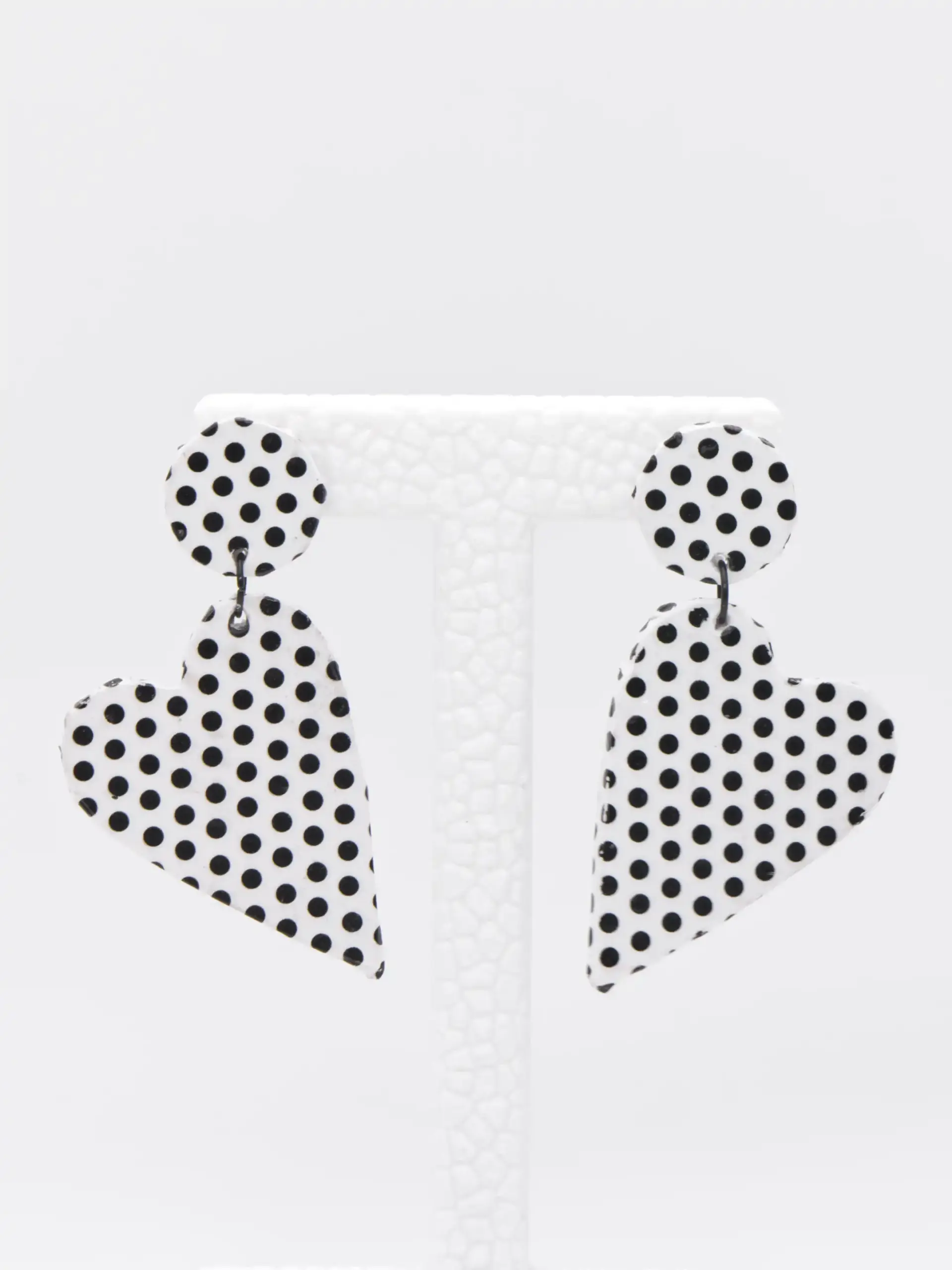 White black polka dot teardrop earrings on display stand