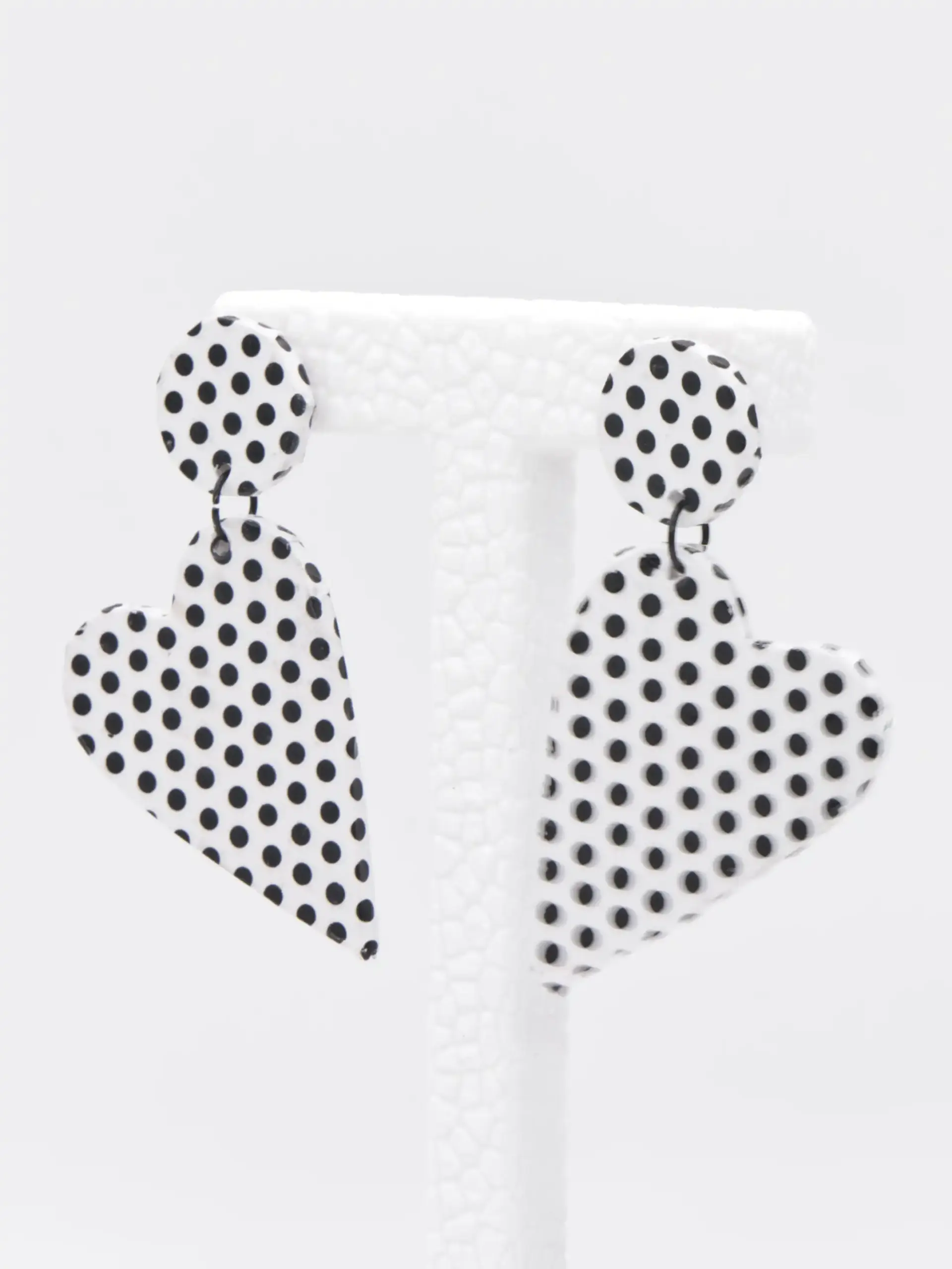 White black polka-dot heart earrings on display