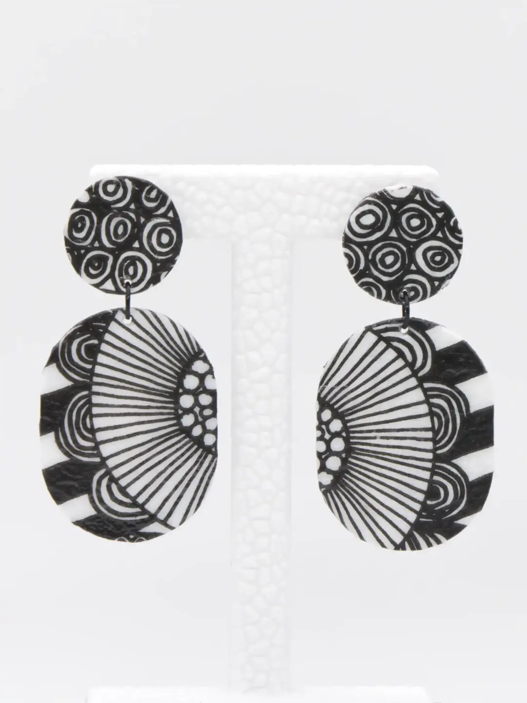 Black and white patterned circular dangle earrings