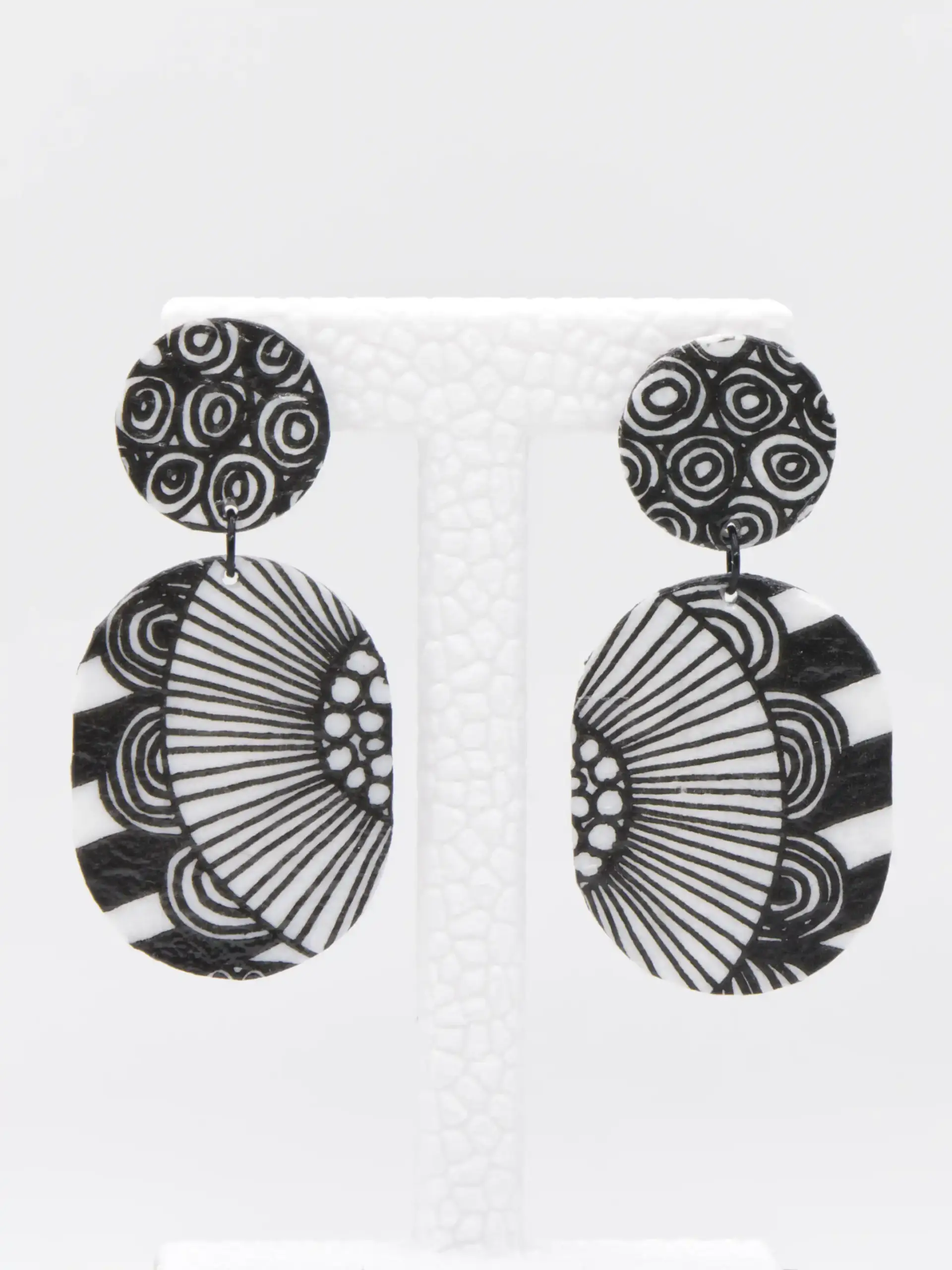 Black and white patterned circular dangle earrings