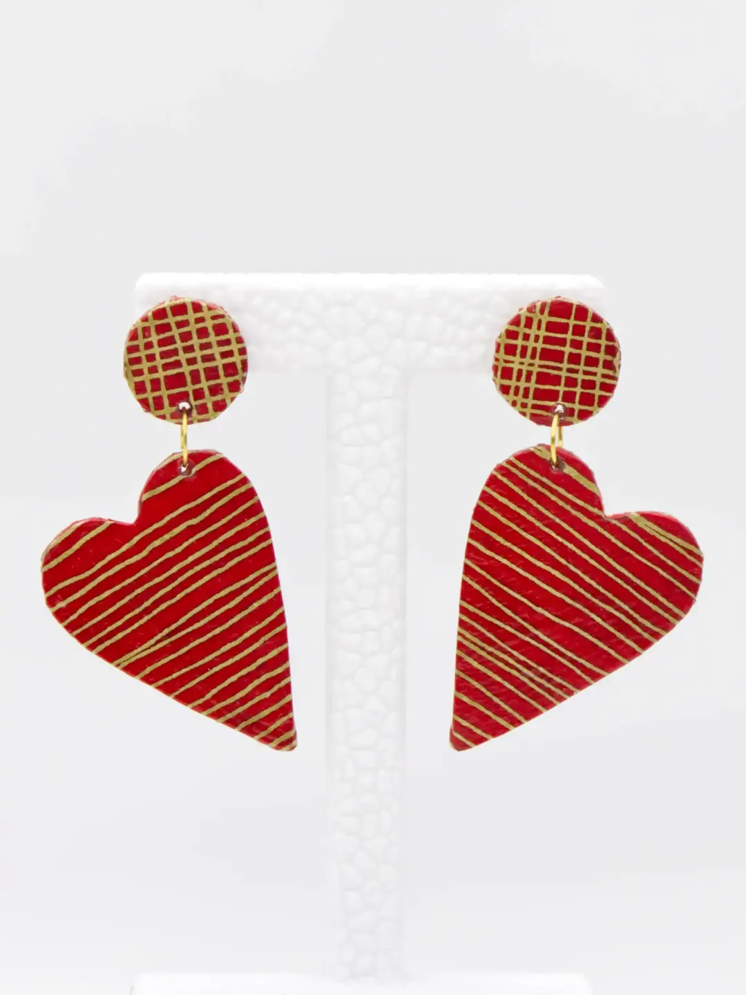 Red heart drop earrings with gold diagonal stripes