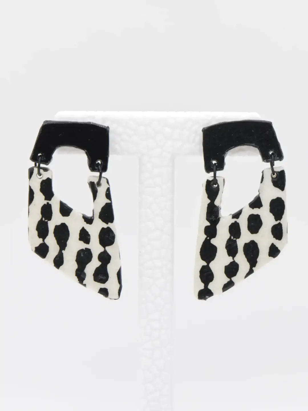 Black and white cow-print dangling earrings