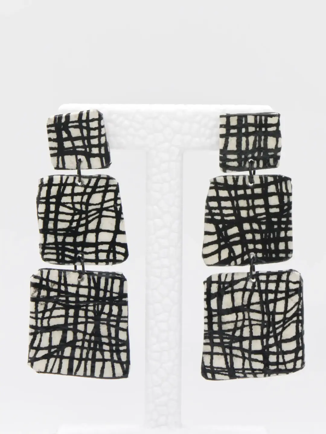 Black and white geometric three-tier statement earrings
