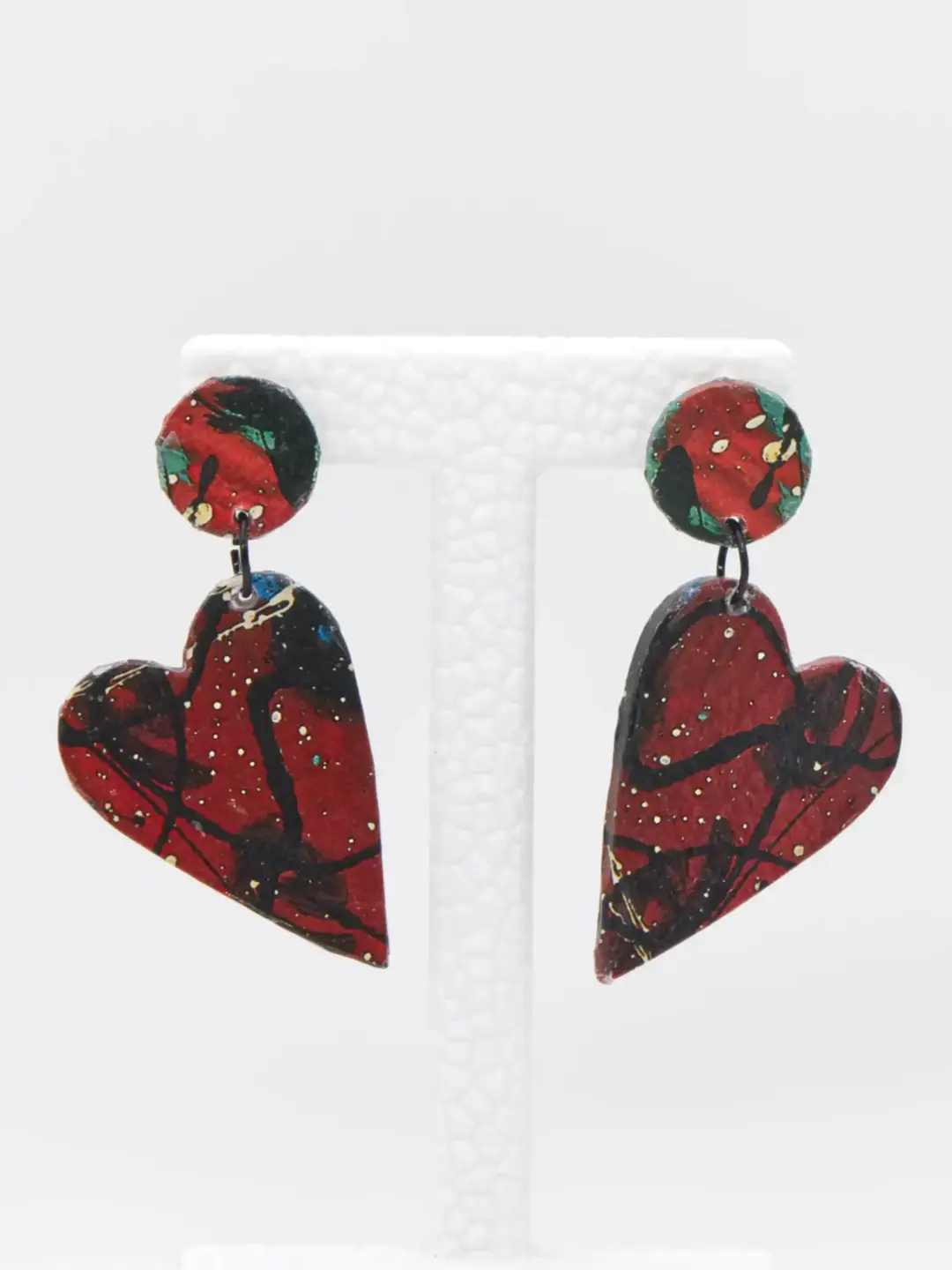 Red and black abstract double-drop earrings on white stand